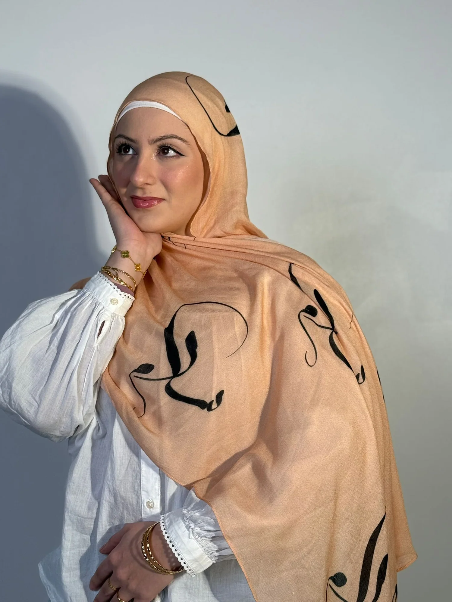 Woman wearing peach scarf from the Salaam Exclusive collection